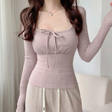 リボンと長袖が付いたニット風のマジカルソフトガールトップス